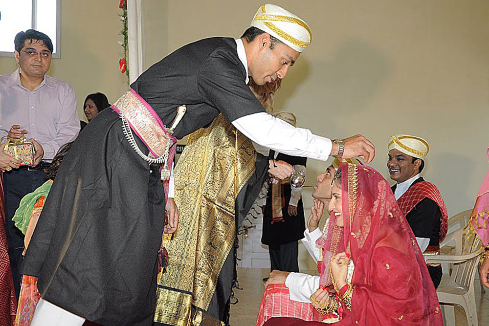 Coorg wedding guest blessing the bride.